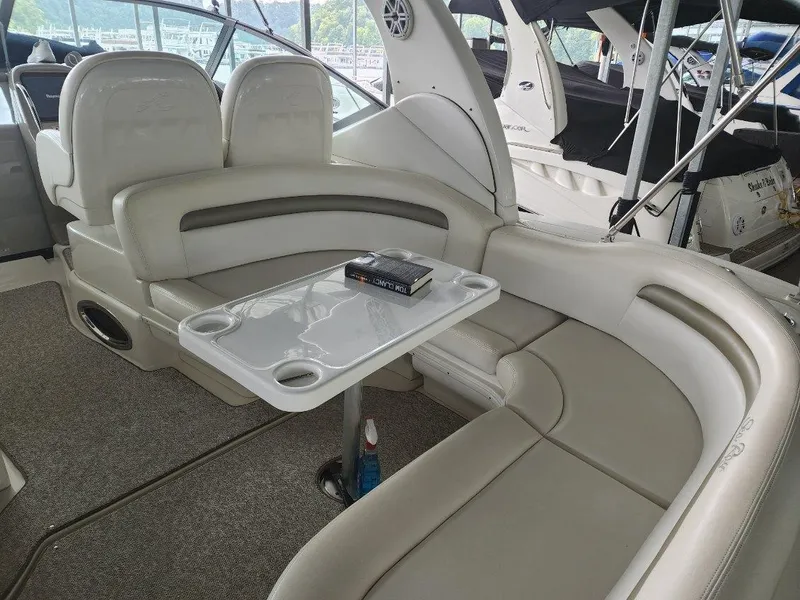 Slide: The Image of Interior seating area of a 2006 Sea Ray 340 Sundancer yacht with a table. - 14