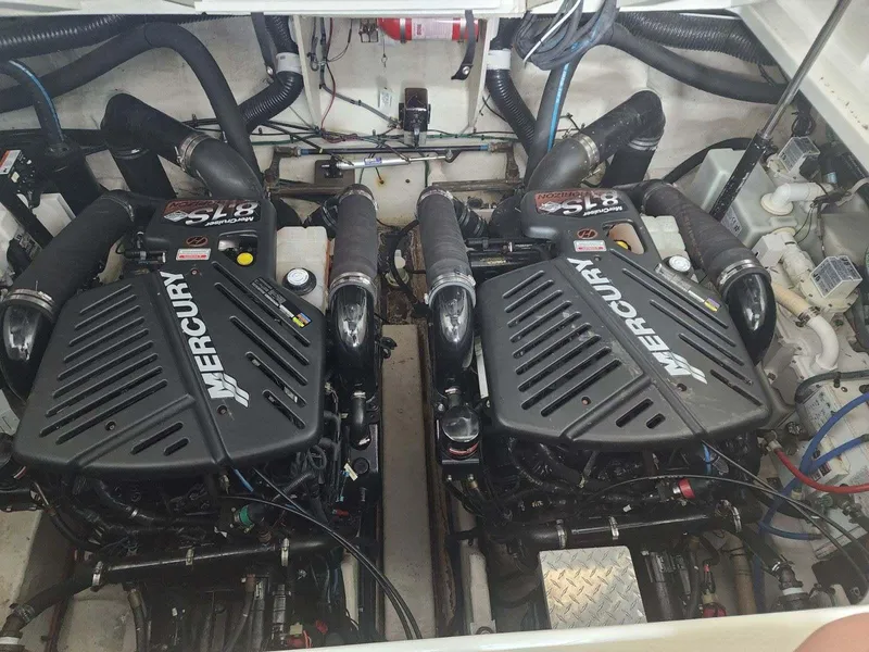 Slide: The Image of 2006 Sea Ray 340 Sundancer engine compartment with twin Mercury engines. - 17