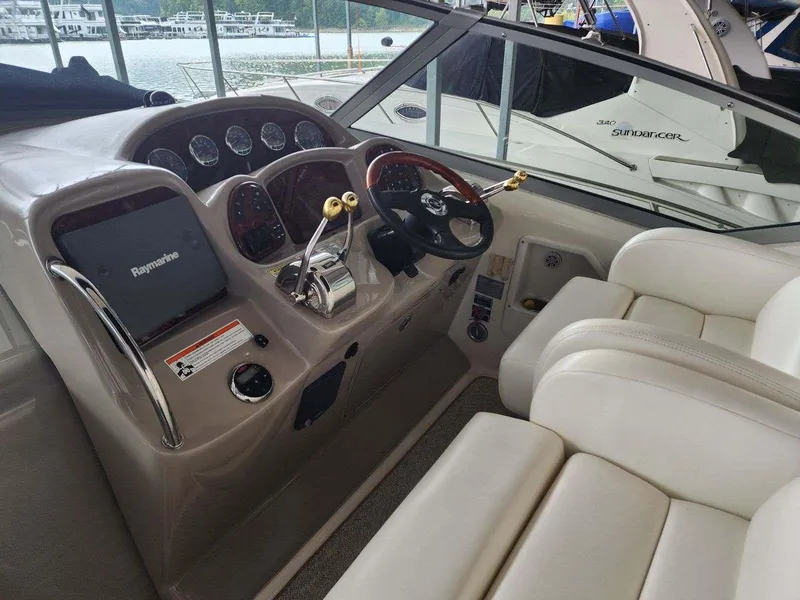 Slide: The Image of 2006 Sea Ray 340 Sundancer helm with modern controls and comfortable seating. - 2
