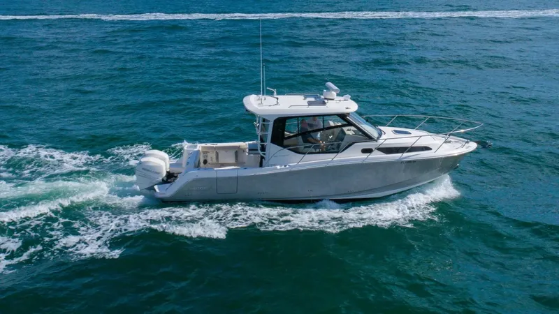 Slide: The Image of 2020 Boston Whaler 325 Conquest cruising on open water. - 0