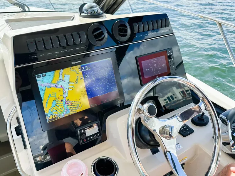 Slide: The Image of Control panel of a 2020 Boston Whaler 325 Conquest boat with navigation screens. - 33