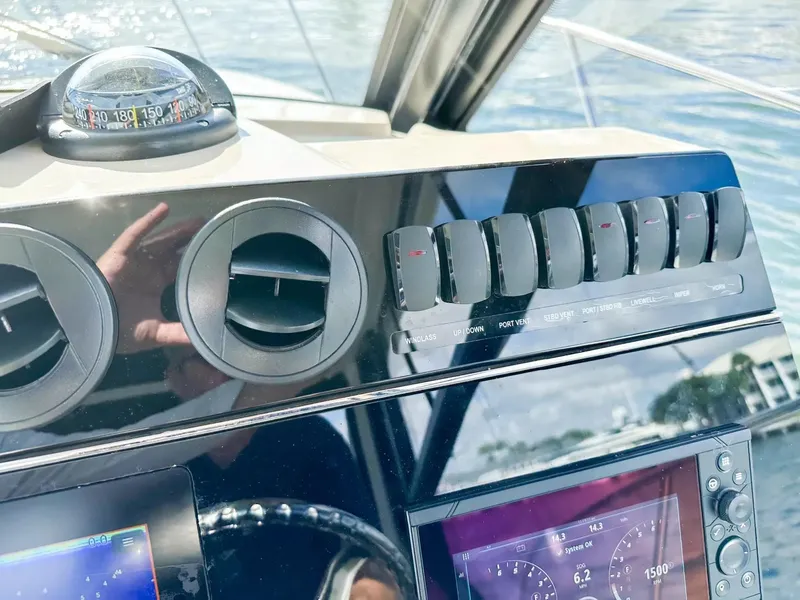 Slide: The Image of Control panel of a 2020 Boston Whaler 325 Conquest boat with navigation instruments. - 38