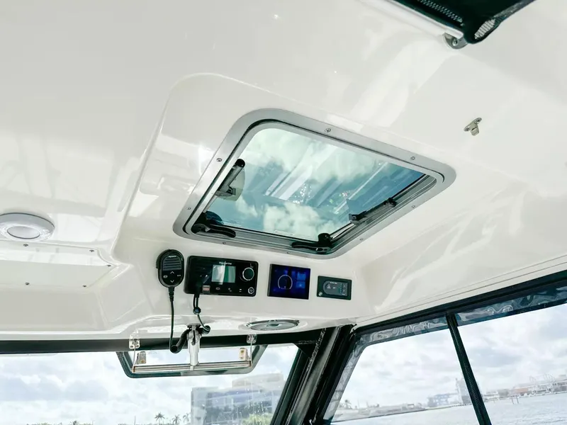 Slide: The Image of Interior roof of 2020 Boston Whaler 325 Conquest with skylight and control panel. - 42