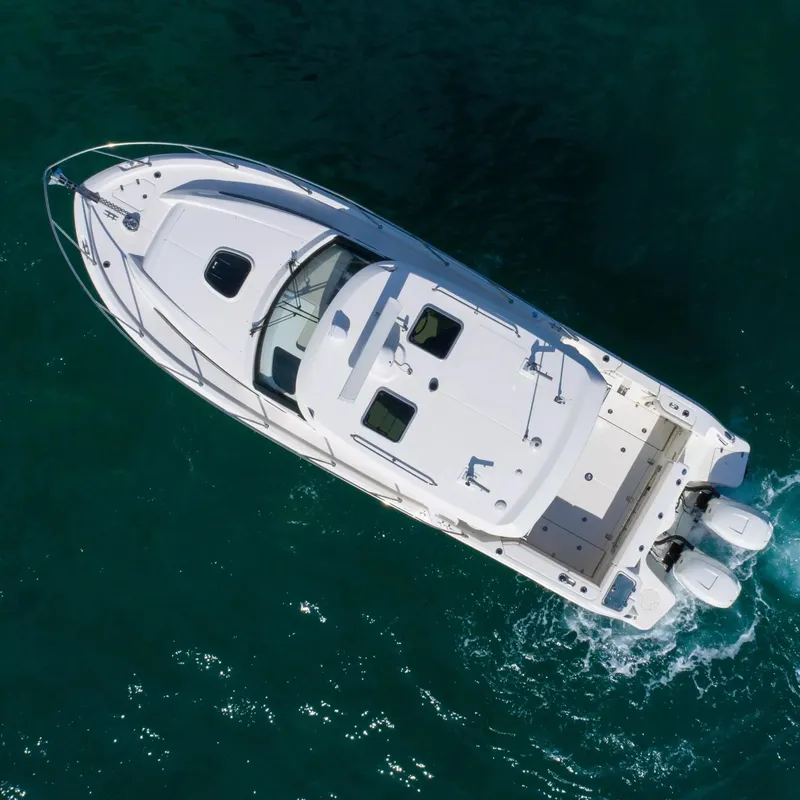Slide: The Image of Aerial view of a 2020 Boston Whaler 325 Conquest boat cruising on water. - 7