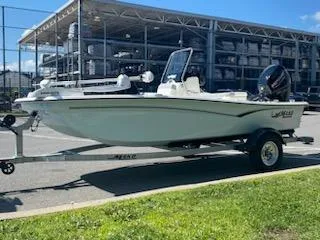 Slide: The Image of 2024 Mako Pro Skiff 15 CC boat on trailer, parked outdoors. - 2