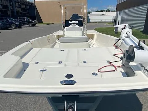 Slide: The Image of 2024 Mako Pro Skiff 15 CC boat in a parking lot, featuring a spacious deck. - 4