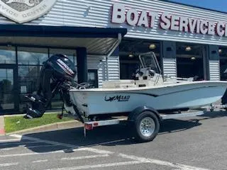 Slide: The Image of 2024 Mako Pro Skiff 15 CC boat on trailer outside service center. - 5