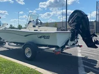 Slide: The Image of 2024 Mako Pro Skiff 15 CC boat on trailer with Mercury outboard motor. - 6