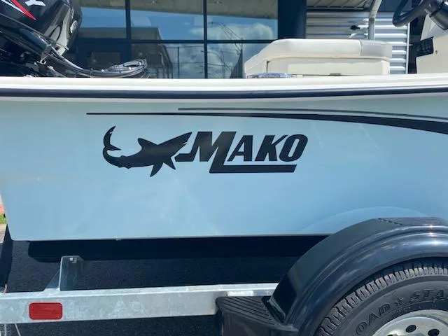 Slide: The Image of 2024 Mako Pro Skiff 15 CC boat with logo on trailer. - 7