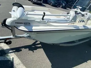 Slide: The Image of 2024 Mako Pro Skiff 15 CC with Minn Kota motor on trailer in parking lot. - 8