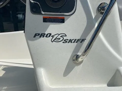 Slide: The Image of 2024 Mako Pro Skiff 15 CC boat console with logo detail. - 9