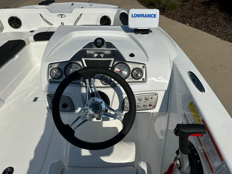 Slide: The Image of 2024 Tahoe 1950 boat dashboard with steering wheel and Lowrance navigation system. - 4