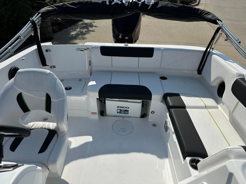 Slide: The Image of 2024 Tahoe 1950 boat interior with seating and Igloo cooler. - 6