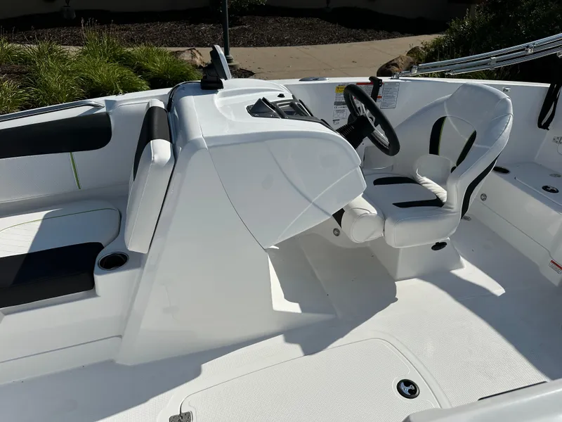 Slide: The Image of 2024 Tahoe 1950 boat interior with white seating and steering console. - 7