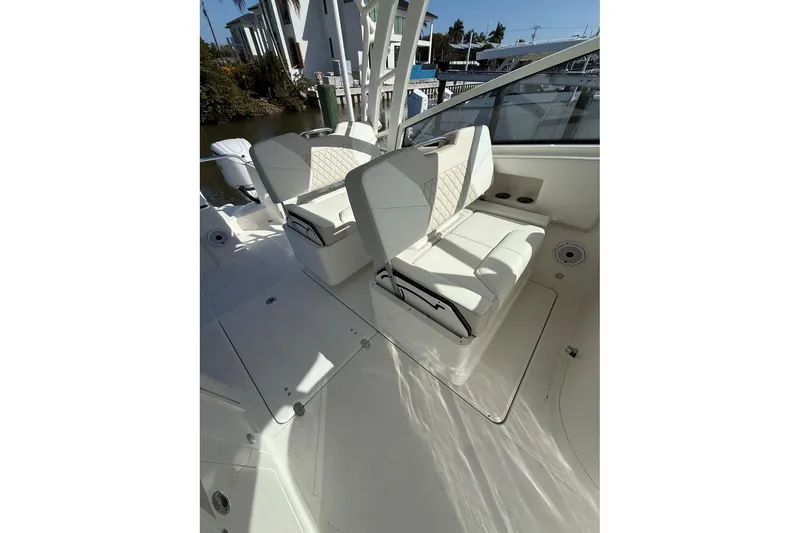 Slide: The Image of 2026 World Cat 325 DC boat interior with white seating and sleek design. - 10