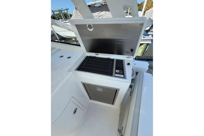 Slide: The Image of 2026 World Cat 325 DC boat grill station with storage compartment. - 12