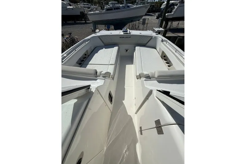 Slide: The Image of 2026 World Cat 325 DC boat interior with white seating and open deck. - 13