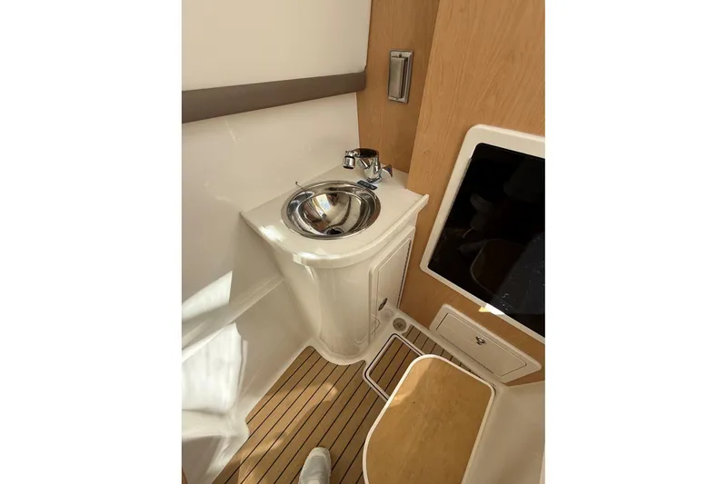 Slide: The Image of 2026 World Cat 325 DC boat interior with sink and wooden flooring. - 14