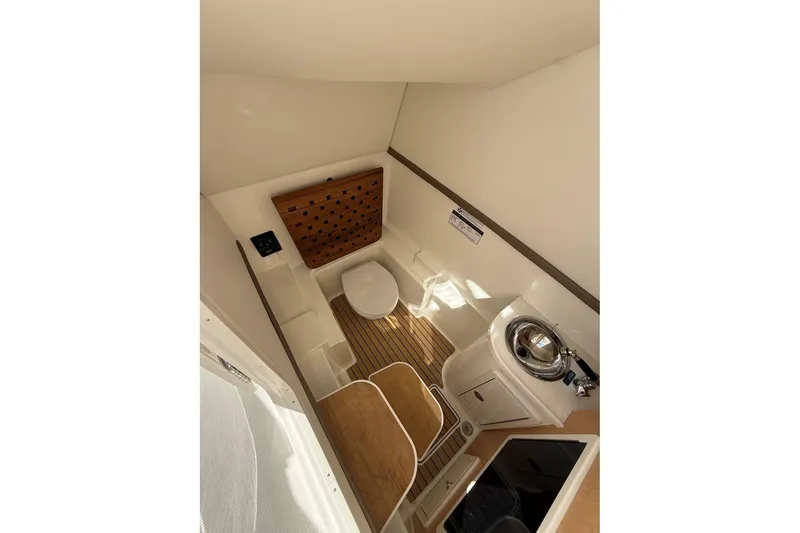 Slide: The Image of Luxurious bathroom interior of 2026 World Cat 325 DC boat with wooden flooring. - 15