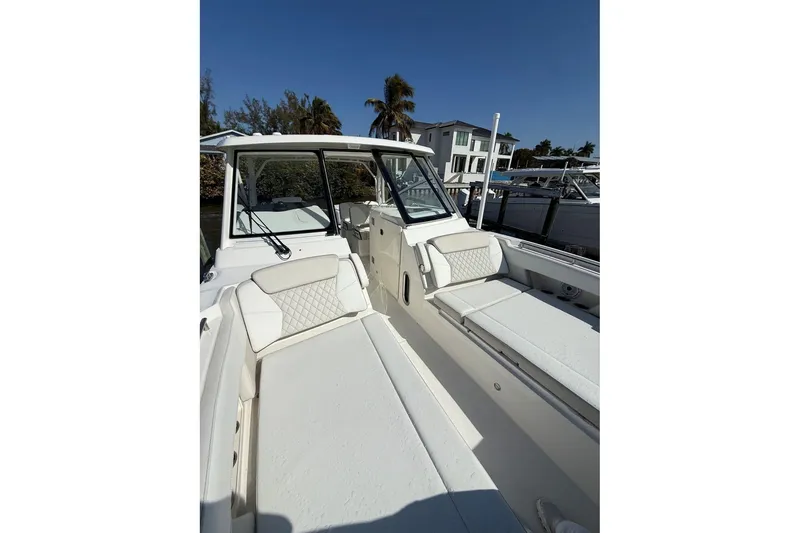 Slide: The Image of 2026 World Cat 325 DC boat interior with white seating and modern design. - 18