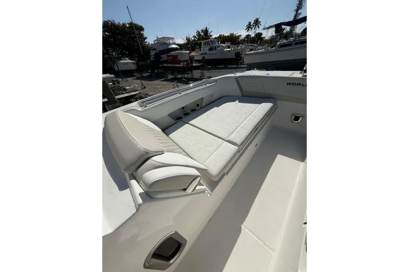Slide: The Image of 2026 World Cat 325 DC boat interior with cushioned seating area. - 19