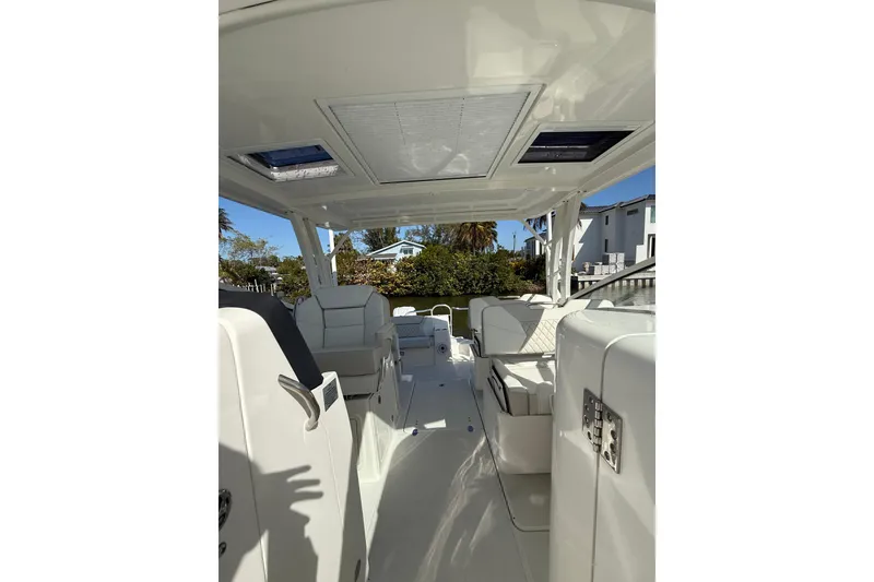 Slide: The Image of Interior view of 2026 World Cat 325 DC boat, featuring sleek seating and modern design. - 21
