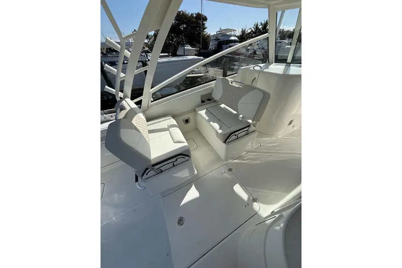 Slide: The Image of Interior of 2026 World Cat 325 DC boat featuring sleek white seating and modern design. - 6