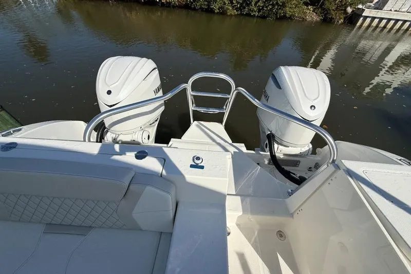 Slide: The Image of 2026 World Cat 325 DC boat with dual Yamaha outboard engines on calm water. - 8