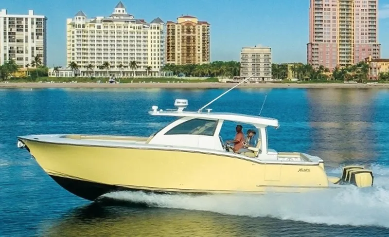 Slide: The Image of 2019 Altima Xcape Sport 38 SFE boat cruising near waterfront cityscape. - 0