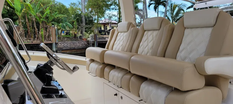 Slide: The Image of Luxurious seating on 2019 Altima Xcape Sport 38 SFE boat, featuring plush beige upholstery. - 12