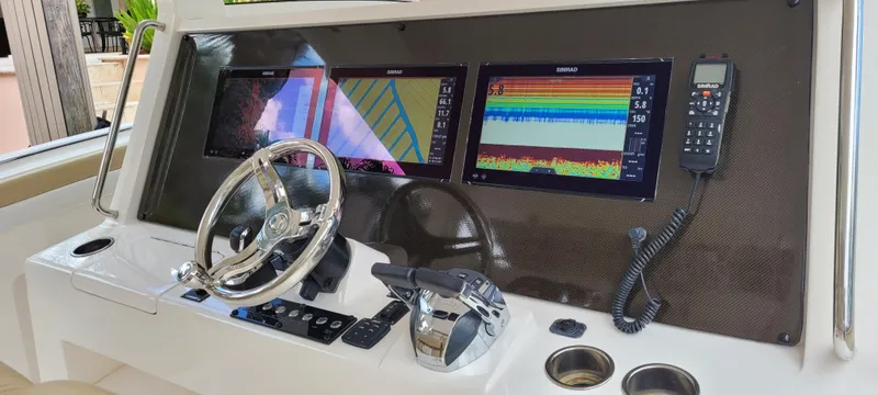 Slide: The Image of 2019 Altima Xcape Sport 38 SFE dashboard with dual navigation screens and controls. - 14