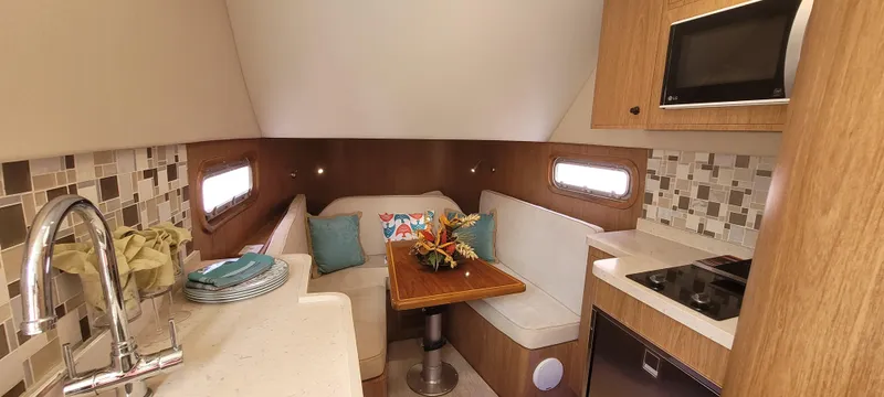 Slide: The Image of 2019 Altima Xcape Sport 38 SFE interior with cozy seating, kitchenette, and modern decor. - 16