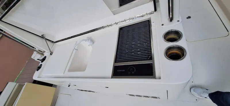 Slide: The Image of 2019 Altima Xcape Sport 38 SFE boat kitchen area with grill and sink. - 19