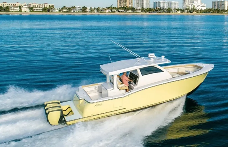 Slide: The Image of 2019 Altima Xcape Sport 38 SFE boat cruising on blue water near city skyline. - 3