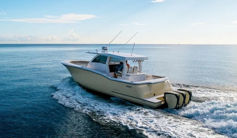 Slide: The Image of 2019 Altima Xcape Sport 38 SFE boat cruising on open water. - 4