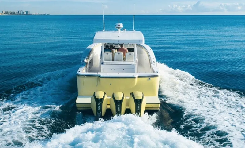 Slide: The Image of 2019 Altima Xcape Sport 38 SFE boat cruising on open water. - 5