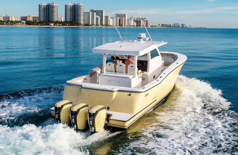 Slide: The Image of 2019 Altima Xcape Sport 38 SFE cruising on ocean near city skyline. - 6