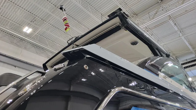 Slide: The Image of 2025 Formula 380 Super Sport Crossover OB boat in a showroom. - 11