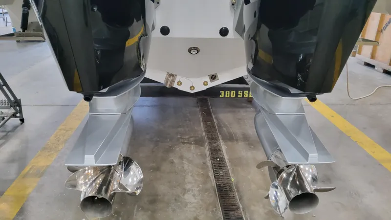 Slide: The Image of 2025 Formula 380 Super Sport Crossover OB boat propellers in a workshop. - 13