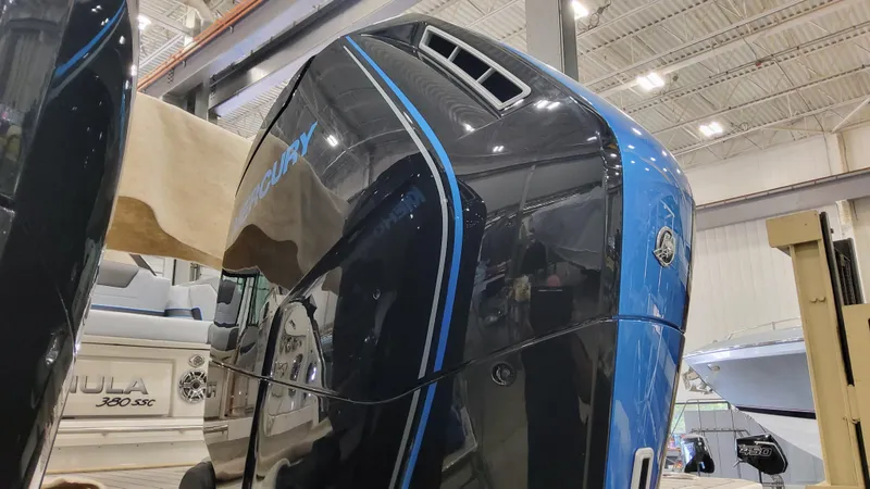 Slide: The Image of 2025 Formula 380 Super Sport Crossover OB in showroom, close-up of outboard motor. - 14