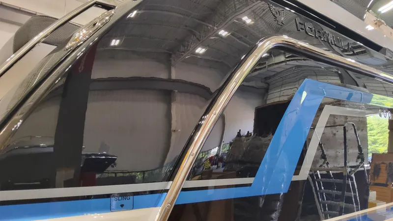 Slide: The Image of 2025 Formula 380 Super Sport Crossover OB boat in a showroom. - 18