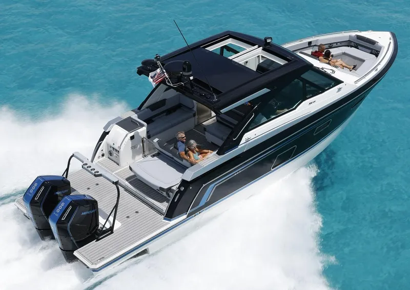 Slide: The Image of 2025 Formula 380 Super Sport Crossover OB cruising on clear blue water. - 2