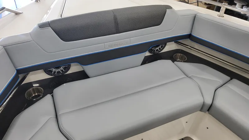 Slide: The Image of 2025 Formula 380 Super Sport Crossover OB boat interior with gray seating and cup holders. - 25