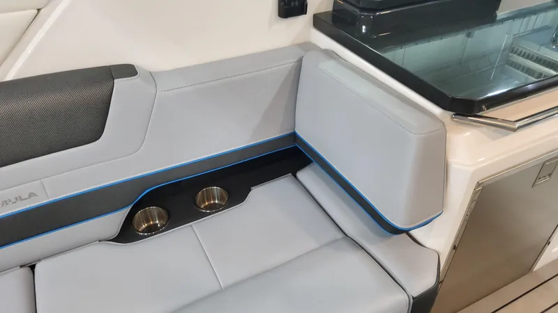 Slide: The Image of 2025 Formula 380 Super Sport Crossover OB interior seating with cup holders and kitchenette. - 45