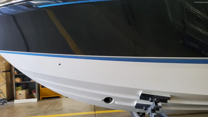 Slide: The Image of 2025 Formula 380 Super Sport Crossover OB boat hull in a workshop. - 8