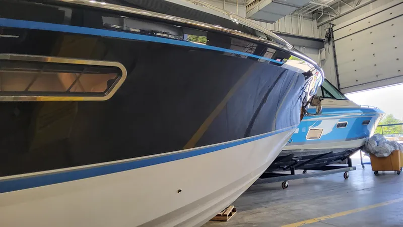 Slide: The Image of 2025 Formula 380 Super Sport Crossover OB boats in a warehouse. - 9