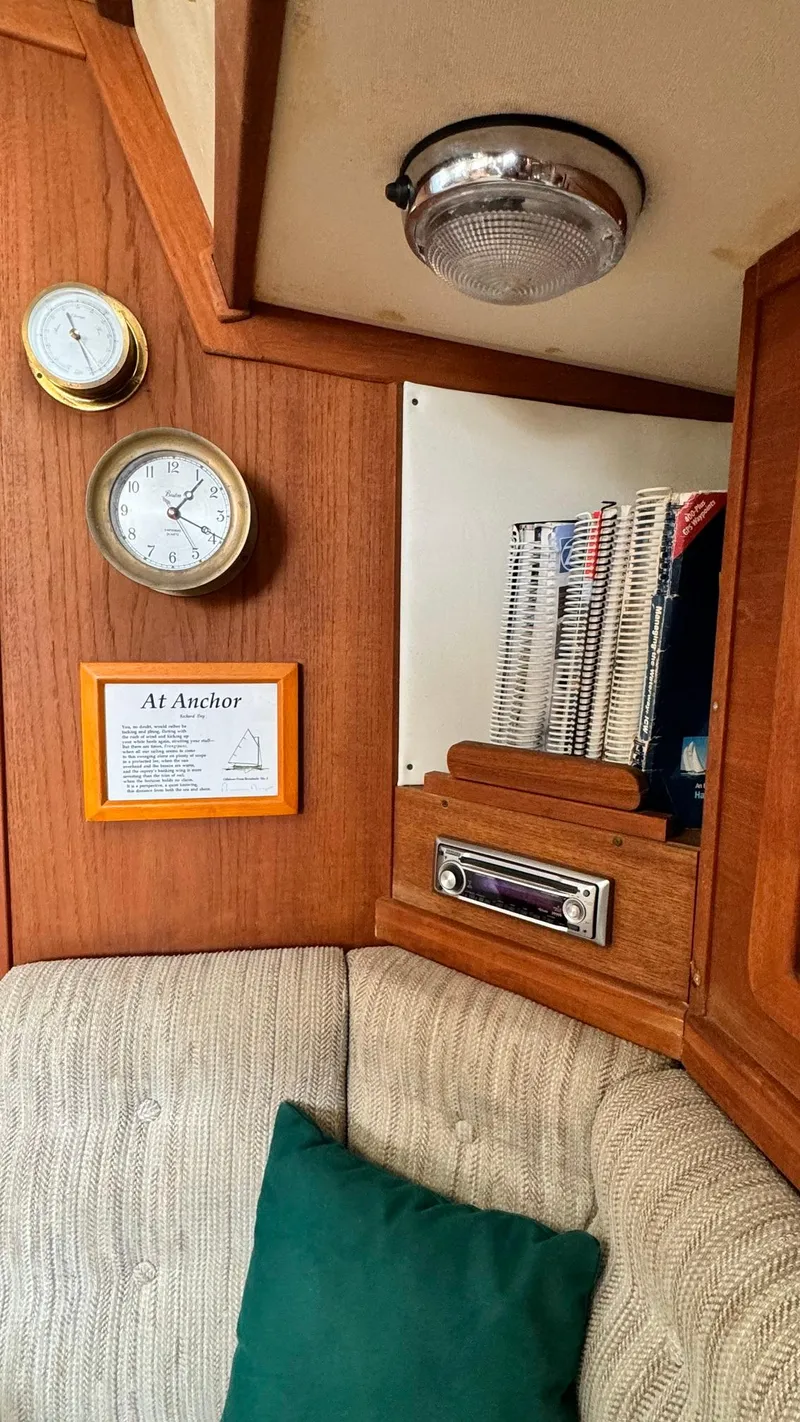 Slide: The Image of Interior of 1990 Sabre 38 sailboat with clock, barometer, and cozy seating area. - 14