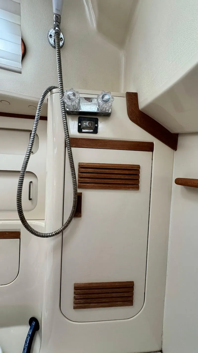 Slide: The Image of Interior of 1990 Sabre 38 sailboat with shower and wooden accents. - 16