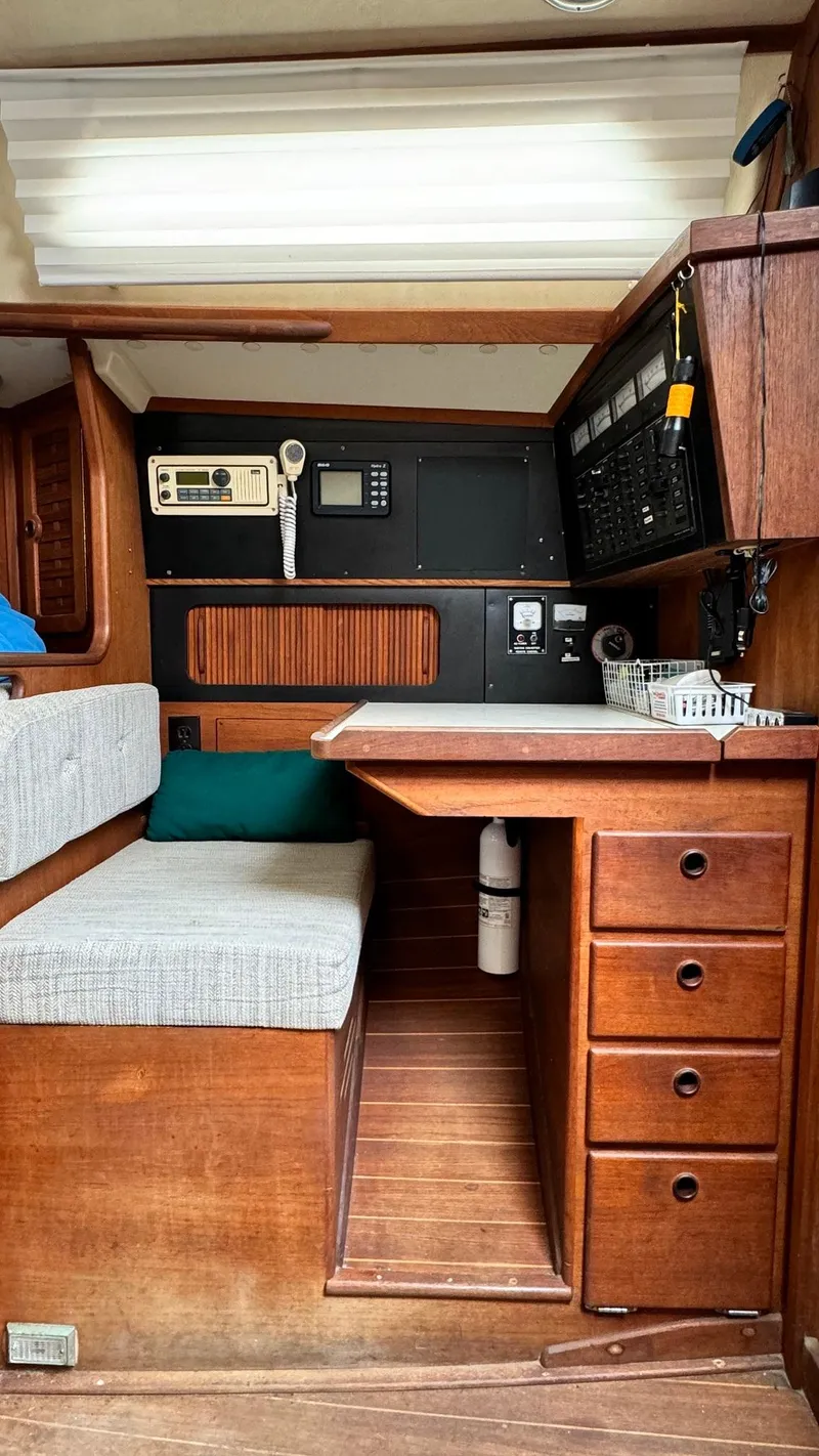 Slide: The Image of 1990 Sabre 38 yacht interior with navigation station and wooden cabinetry. - 17