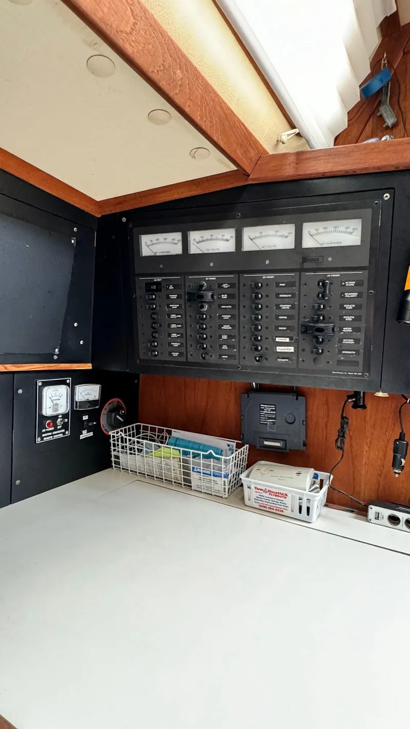 Slide: The Image of Electrical panel inside a 1990 Sabre 38 sailboat, featuring gauges and switches. - 18